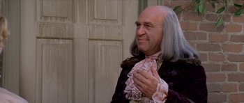 Movie still from “1776” (1972), directed by Peter H. Hunt – A man in a wig and wig clasping his hands; Close Up shot, Over the shoulder angle