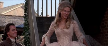Movie still from “1776” (1972), directed by Peter H. Hunt – A woman in a pink dress sitting on some stairs; Medium shot, Low angle