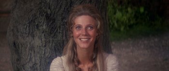 Movie still from “1776” (1972), directed by Peter H. Hunt – A person smiling near a tree; Close Up shot, Over the shoulder angle