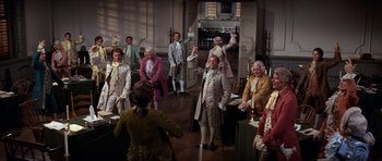 Movie still from “1776” (1972), directed by Peter H. Hunt – A group of people dressed in period costumes; Wide shot, High angle