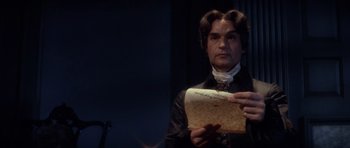 Movie still from “1776” (1972), directed by Peter H. Hunt – A man holding a piece of paper in front of him; Close Up shot, Over the shoulder angle