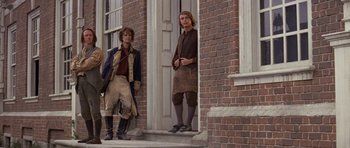 Movie still from “1776” (1972), directed by Peter H. Hunt – Two people standing on the steps of a building; Wide shot, Low angle
