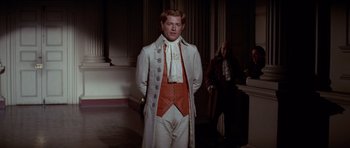 Movie still from “1776” (1972), directed by Peter H. Hunt – A man in a white coat standing in a room; Medium shot, Over the shoulder angle