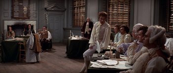 Movie still from “1776” (1972), directed by Peter H. Hunt – A group of people sitting around a table; Wide shot, Over the shoulder angle