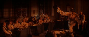 Movie still from “1776” (1972), directed by Peter H. Hunt – A group of people sitting around a table; Wide shot, Over the shoulder angle