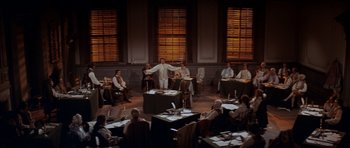 Movie still from “1776” (1972), directed by Peter H. Hunt – A group of people sitting around a room; Extreme Wide shot, High angle