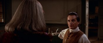 Movie still from “1776” (1972), directed by Peter H. Hunt – A man wearing a wig talking to another man; Medium shot, Over the shoulder angle