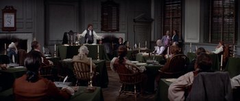 Movie still from “1776” (1972), directed by Peter H. Hunt – A group of people sitting around a room; Wide shot, High angle