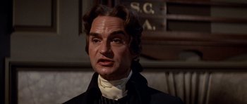Movie still from “1776” (1972), directed by Peter H. Hunt – A wax figure of a man in a black suit; Close Up shot, Low angle