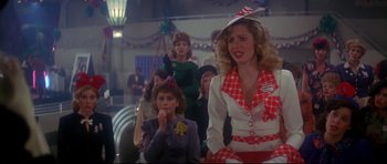 Movie still from “1941” (1979), directed by Steven Spielberg – A group of people sitting in a room; Medium shot, Over the shoulder angle