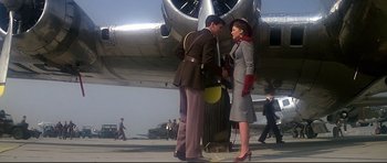 Movie still from “1941” (1979), directed by Steven Spielberg – A man and a woman standing in front of an airplane; Wide shot, Low angle