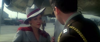 Movie still from “1941” (1979), directed by Steven Spielberg – A woman wearing a hat talking to a man in a uniform; Close Up shot, Over the shoulder angle