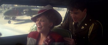 Movie still from “1941” (1979), directed by Steven Spielberg – A woman sitting in the back seat of a car with a man; Close Up shot, Over the shoulder angle