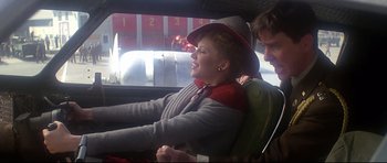 Movie still from “1941” (1979), directed by Steven Spielberg – A man and a woman sitting in the back seat of a car; Medium shot, Over the shoulder angle