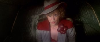 Movie still from “1941” (1979), directed by Steven Spielberg – A woman wearing a hat and holding a bunch of grapes; Close Up shot, Low angle