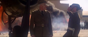 Movie still from “1941” (1979), directed by Steven Spielberg – An older man in a military uniform stands in front of smoke; Medium shot, Low angle