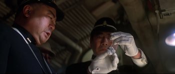 Movie still from “1941” (1979), directed by Steven Spielberg – A man in a uniform holding a key chain; Close Up shot, High angle