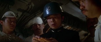 Movie still from “1941” (1979), directed by Steven Spielberg – A man wearing a helmet is standing next to another man; Close Up shot, Low angle