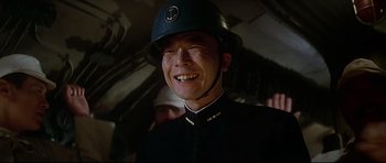 Movie still from “1941” (1979), directed by Steven Spielberg – A man wearing a helmet smiles for the camera; Close Up shot, Low angle