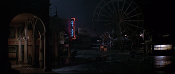 Movie still from “1941” (1979), directed by Steven Spielberg – A neon sign is lit up in the middle of the night; Extreme Wide shot, High angle
