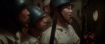 Movie still from “1941” (1979), directed by Steven Spielberg – A group of men in military uniforms with helmets on; Close Up shot, High angle