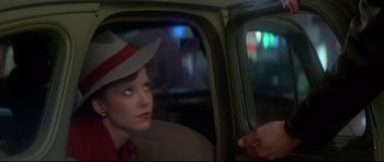 Movie still from “1941” (1979), directed by Steven Spielberg – A woman wearing a hat sitting in the back of a car; Close Up shot, Over the shoulder angle