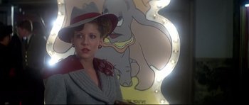 Movie still from “1941” (1979), directed by Steven Spielberg – A woman wearing a hat and a gray coat; Close Up shot, Low angle