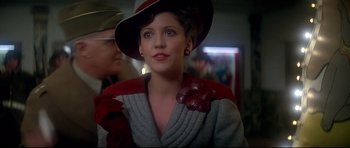 Movie still from “1941” (1979), directed by Steven Spielberg – A woman wearing a red hat and a gray sweater; Close Up shot, Over the shoulder angle