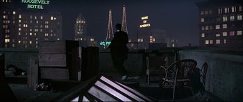 Movie still from “1941” (1979), directed by Steven Spielberg – A man walking on the roof of a building at night; Extreme Wide shot, Low angle