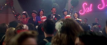 Movie still from “1941” (1979), directed by Steven Spielberg – A group of people singing in front of an audience; Medium shot, Low angle