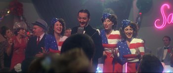 Movie still from “1941” (1979), directed by Steven Spielberg – A group of people dressed in american flag themed clothing; Medium shot, Low angle