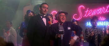 Movie still from “1941” (1979), directed by Steven Spielberg – A group of men in suits and hats singing; Medium shot, Low angle