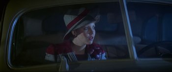 Movie still from “1941” (1979), directed by Steven Spielberg – A woman in a hat looking out of a car window; Close Up shot, Over the shoulder angle