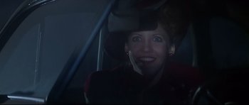 Movie still from “1941” (1979), directed by Steven Spielberg – A woman in a hat sitting in a car; Close Up shot, Over the shoulder angle