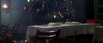 Movie still from “1941” (1979), directed by Steven Spielberg – A table with a cake on top of it; Wide shot, High angle