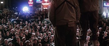 Movie still from “1941” (1979), directed by Steven Spielberg – A large crowd of people in uniform sitting in front of a man; Wide shot, High angle