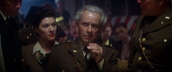 Movie still from “1941” (1979), directed by Steven Spielberg – An older man in a military uniform smoking a cigarette; Close Up shot, Low angle