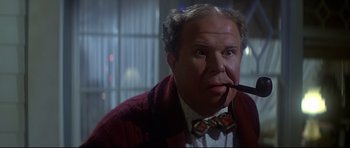 Movie still from “1941” (1979), directed by Steven Spielberg – A person with a pipe in his mouth; Close Up shot, Low angle