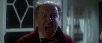 Movie still from “1941” (1979), directed by Steven Spielberg – An older man in a red jacket and a bow tie; Close Up shot, Low angle