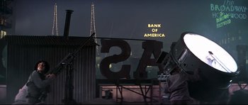 Movie still from “1941” (1979), directed by Steven Spielberg – A sign that reads " bank of america " on the side of a building; Extreme Wide shot, Low angle