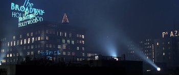 Movie still from “1941” (1979), directed by Steven Spielberg – A building lit up at night with a christmas tree on top of it; Extreme Wide shot, Low angle