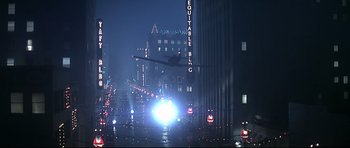 Movie still from “1941” (1979), directed by Steven Spielberg – A plane is flying over a city at night; Extreme Wide shot, Low angle