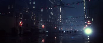 Movie still from “1941” (1979), directed by Steven Spielberg – A city street at night in the rain with lights; Extreme Wide shot, Low angle