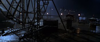 Movie still from “1941” (1979), directed by Steven Spielberg – A view of a pier at night with lights on; Extreme Wide shot, High angle