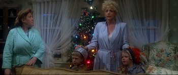 Movie still from “1941” (1979), directed by Steven Spielberg – A woman and two children in front of a christmas tree; Medium shot, Low angle