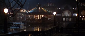Movie still from “1941” (1979), directed by Steven Spielberg – A merry - go - round is lit up at night; Extreme Wide shot, High angle