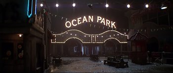 Movie still from “1941” (1979), directed by Steven Spielberg – An ocean park sign is lit up at night; Extreme Wide shot, Low angle