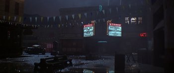 Movie still from “1941” (1979), directed by Steven Spielberg – A rainy night in a city with a lot of lights on; Extreme Wide shot, High angle