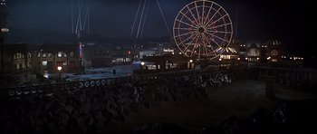 Movie still from “1941” (1979), directed by Steven Spielberg – A large ferris wheel on a pier at night; Extreme Wide shot, High angle