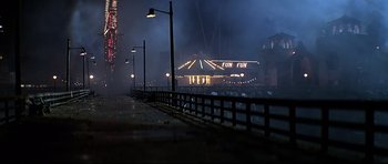 Movie still from “1941” (1979), directed by Steven Spielberg – A view of a carnival ride at night with fog in the background; Extreme Wide shot, High angle
